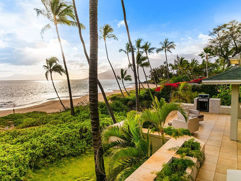 Oceanfront lanai at sunset with BBQ and ocean views